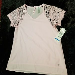 A pink guess shirt